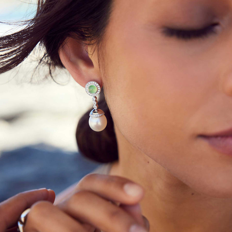 Close up of woman wearing jade and diamond earrings 