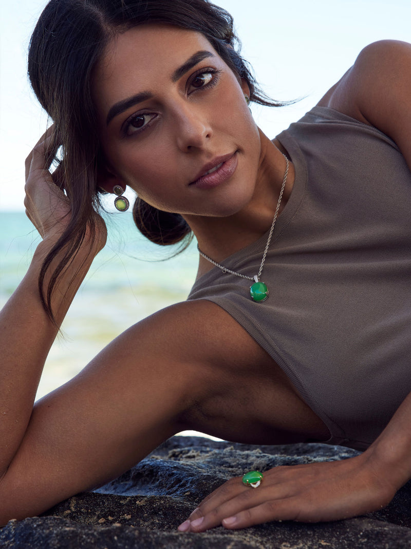 Woman wearing jade pendant, ring and earrings