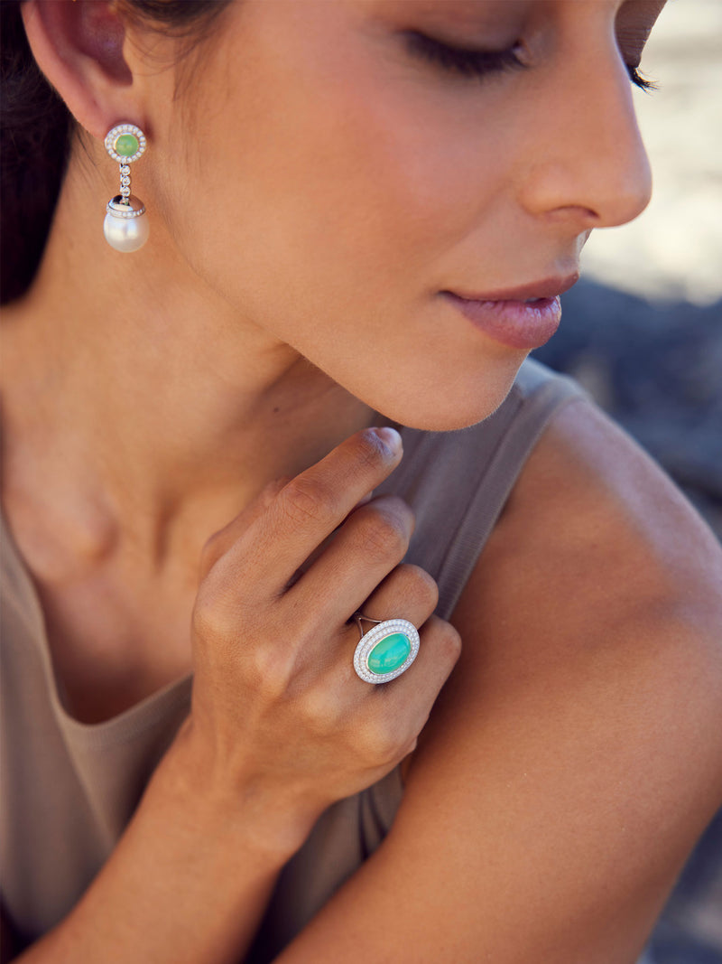 Woman wearing jade and pearl earrings