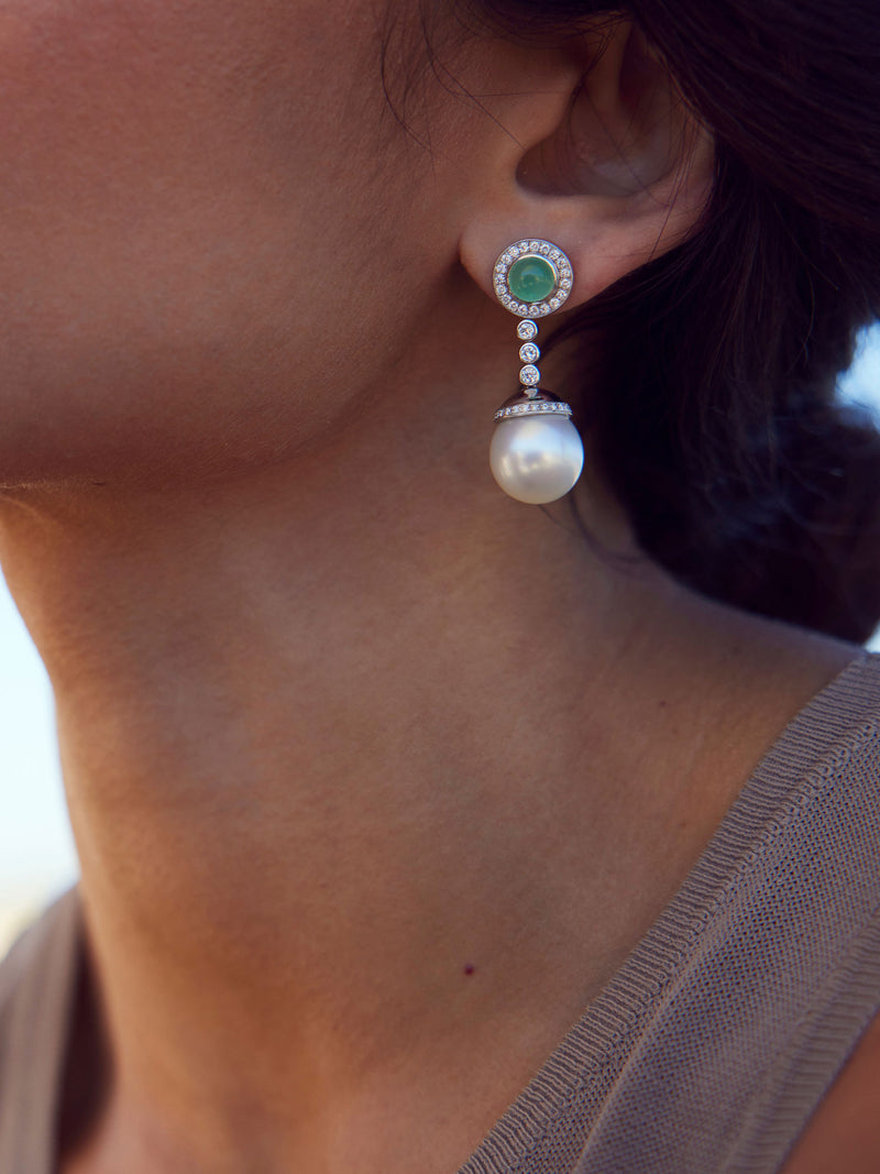 Woman wearing jade and pearl earrings
