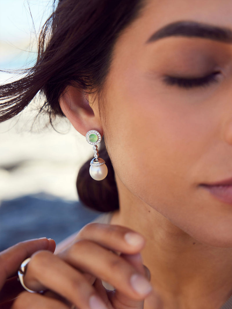 Woman wearing jade and pearl earrings