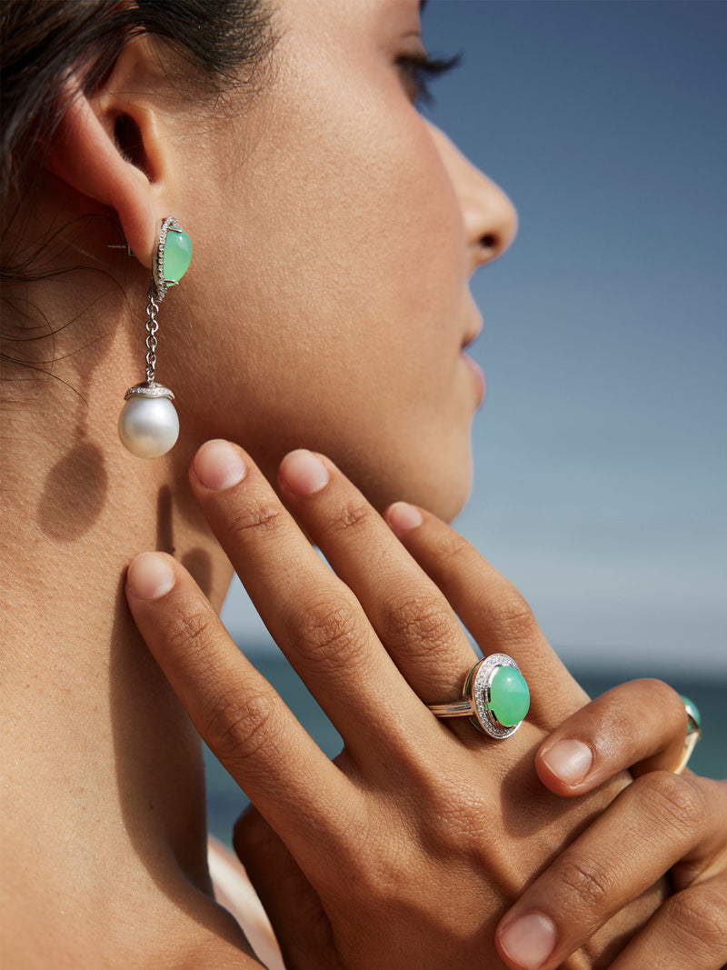 Close up of woman wearing pearl and jade earrings
