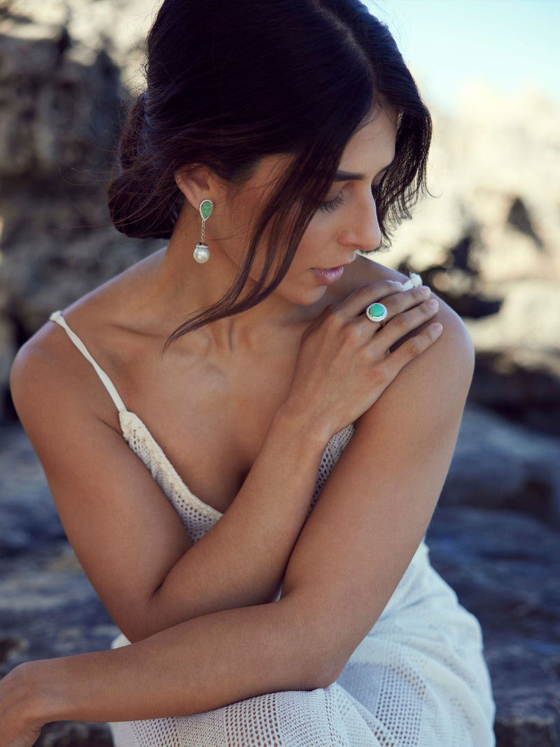 Woman wearing pearl and jade earrings